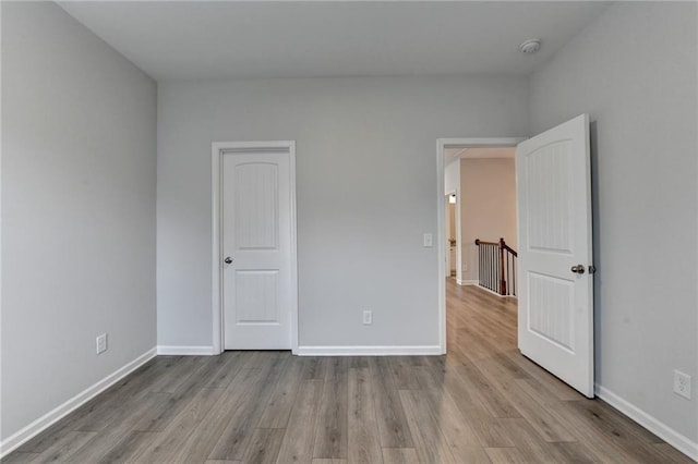 2090 Harvester Ln, Buford, GA 30518 - unfurnished bedroom with wood finished floors and baseboards