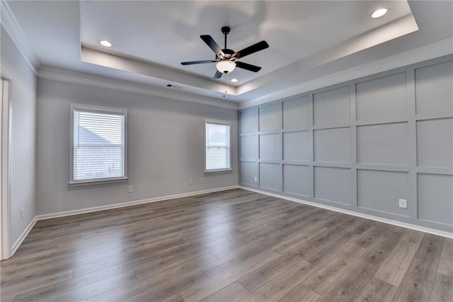 2090 Harvester Ln, Buford, GA 30518 - unfurnished room featuring a raised ceiling, a decorative wall, ceiling fan, crown molding, and wood finished floors