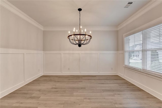 2090 Harvester Ln, Buford, GA 30518 - unfurnished dining area featuring a decorative wall, a chandelier, ornamental molding, light wood-type flooring, and a wainscoted wall