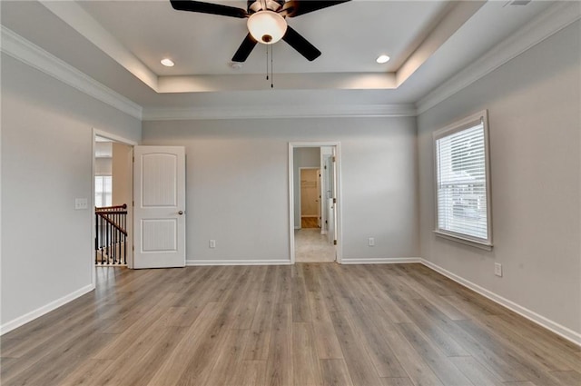 2090 Harvester Ln, Buford, GA 30518 - spare room with a raised ceiling, light wood-type flooring, a ceiling fan, ornamental molding, and recessed lighting