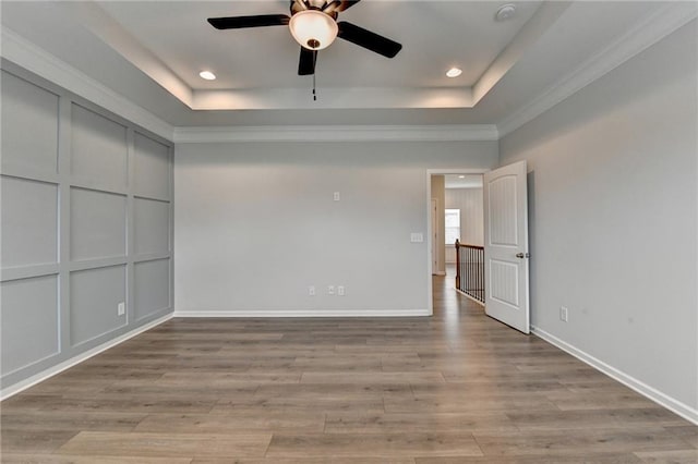 2090 Harvester Ln, Buford, GA 30518 - unfurnished bedroom featuring recessed lighting, a tray ceiling, light wood-type flooring, and ornamental molding