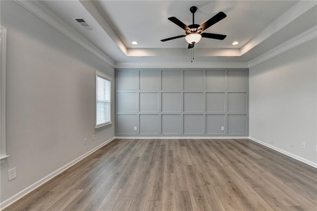 2090 Harvester Ln, Buford, GA 30518 - unfurnished room featuring a raised ceiling, wood finished floors, a ceiling fan, recessed lighting, and crown molding