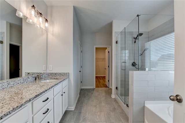 2090 Harvester Ln, Buford, GA 30518 - bathroom with a stall shower, vanity, a walk in closet, and a garden tub