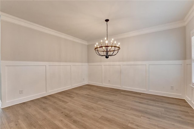 2090 Harvester Ln, Buford, GA 30518 - empty room with a decorative wall, a chandelier, crown molding, a wainscoted wall, and wood finished floors