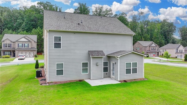 2090 Harvester Ln, Buford, GA 30518 - back of property featuring a lawn, roof with shingles, a patio area, and a residential view