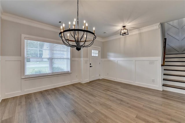 2090 Harvester Ln, Buford, GA 30518 - unfurnished dining area with a decorative wall, a chandelier, a wainscoted wall, ornamental molding, and stairs