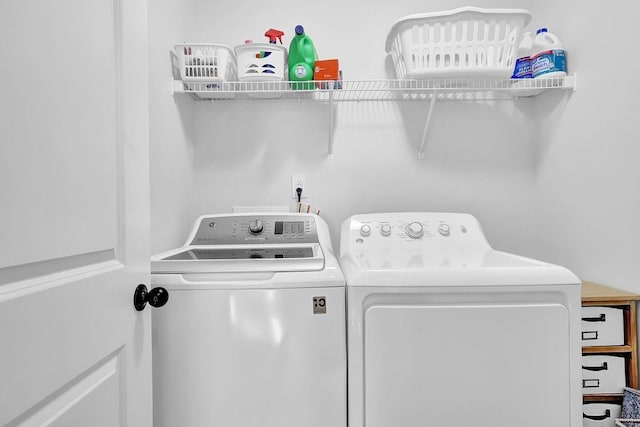 clothes washing area featuring washer and clothes dryer