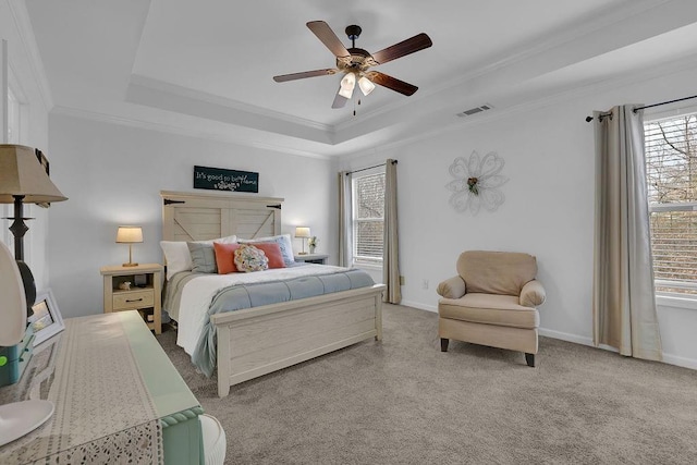 carpeted bedroom featuring ornamental molding, a raised ceiling, and ceiling fan