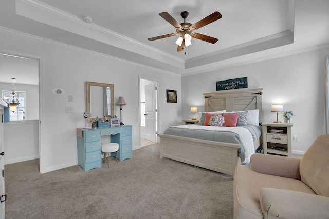 carpeted bedroom with a raised ceiling, crown molding, and ceiling fan