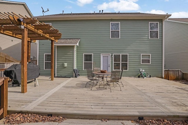 rear view of house featuring a pergola and a deck