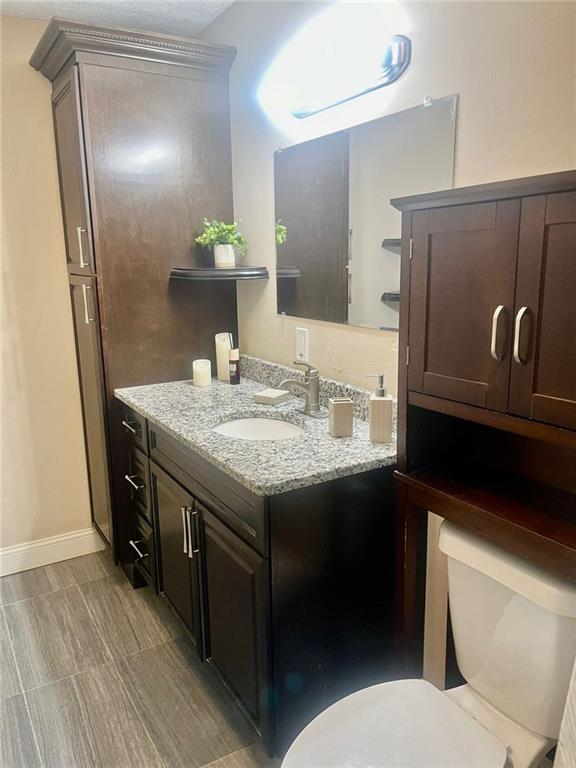 4567 Duncan Dr, Sugar Hill, GA 30518 - bathroom featuring vanity, tile patterned floors, toilet, and curtained shower