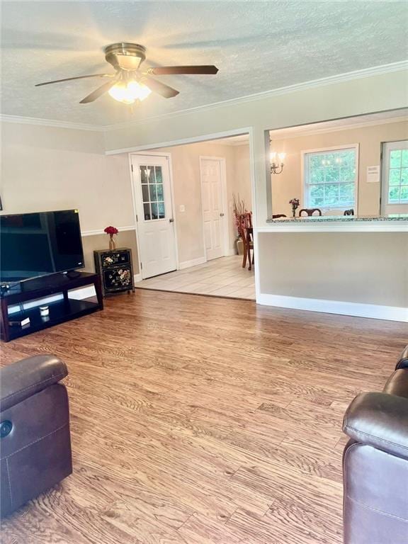 4567 Duncan Dr, Sugar Hill, GA 30518 - living area featuring wood finished floors, a ceiling fan, a textured ceiling, and crown molding