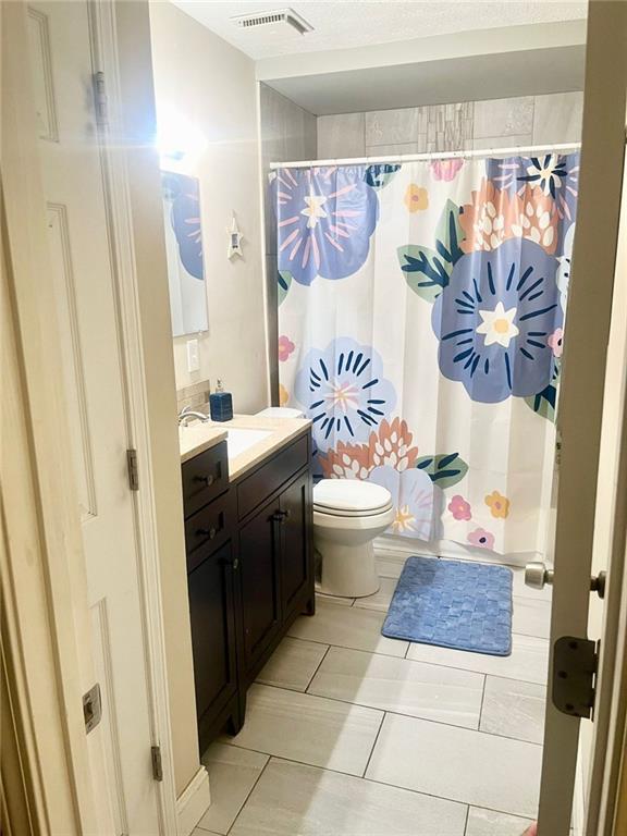 4567 Duncan Dr, Sugar Hill, GA 30518 - hall with wood finished floors, crown molding, a textured ceiling, and baseboards