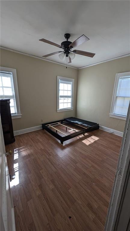 spare room featuring ornamental molding, dark hardwood / wood-style floors, and ceiling fan