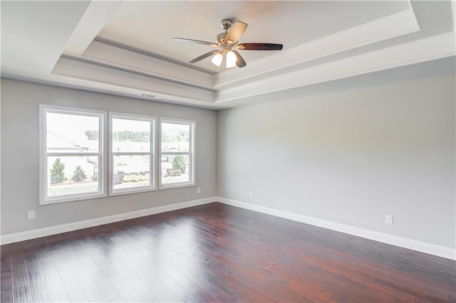 2378 Morgan Creek Rd, Buford, GA 30519 - unfurnished room with a tray ceiling, dark wood-style flooring, and a ceiling fan