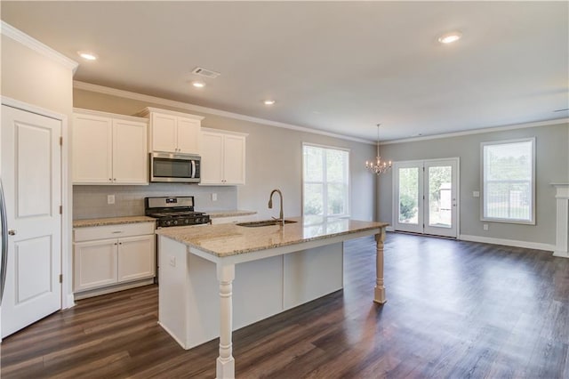 2378 Morgan Creek Rd, Buford, GA 30519 - kitchen with stainless steel appliances, a chandelier, white cabinets, light stone counters, and ornamental molding