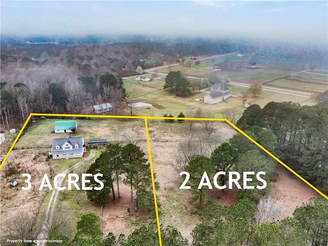 birds eye view of property featuring a rural view