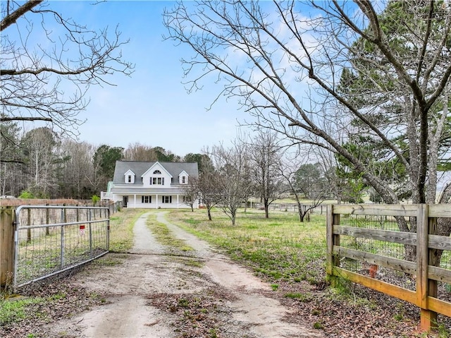 view of street featuring a gated entry, driveway, and a gate