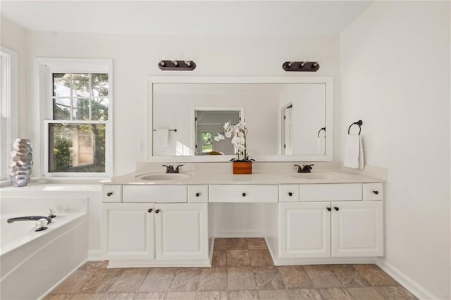 179 Hunters Crk, Dallas, GA 30157 - bathroom with double vanity, a garden tub, and stone finish flooring