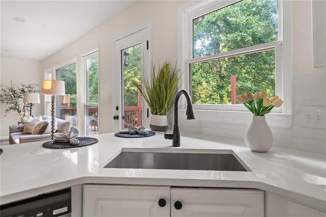 179 Hunters Crk, Dallas, GA 30157 - kitchen view of light countertops, white cabinets, dishwasher, and backsplash