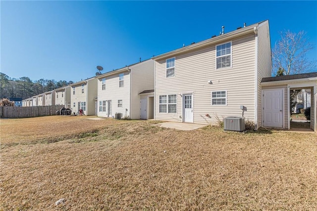 back of property featuring central air condition unit, a yard, and a patio