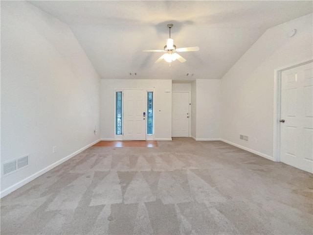 unfurnished room featuring visible vents, light colored carpet, a ceiling fan, and baseboards