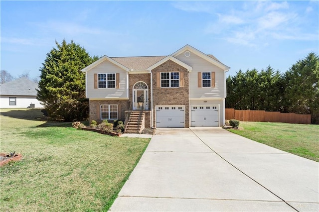 raised ranch featuring a front lawn and a garage