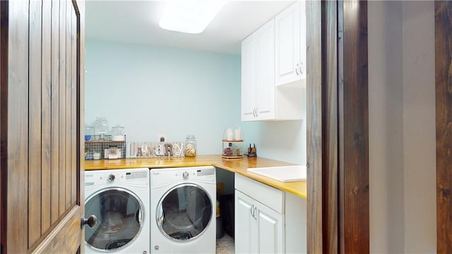 clothes washing area with cabinet space, separate washer and dryer, and a sink