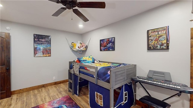 bedroom featuring a ceiling fan, recessed lighting, baseboards, and wood finished floors