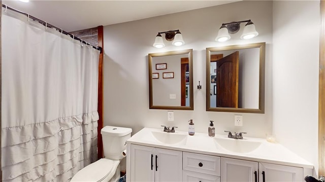 bathroom with a shower with shower curtain, a sink, toilet, and double vanity