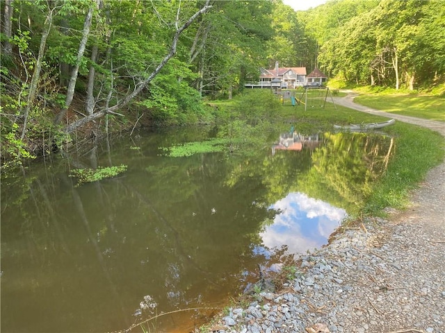 property view of water with a forest view