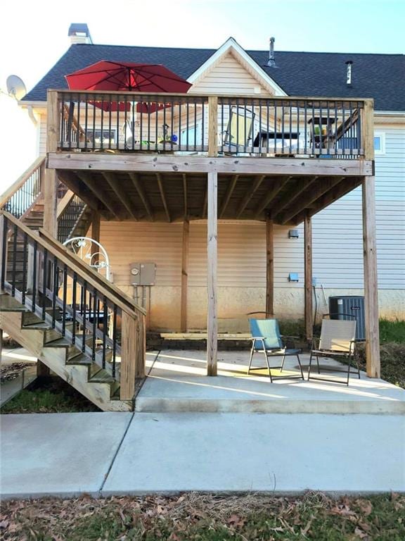 view of patio / terrace with stairway, central air condition unit, and a wooden deck