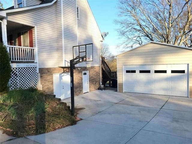 view of side of home featuring a detached garage and an outdoor structure