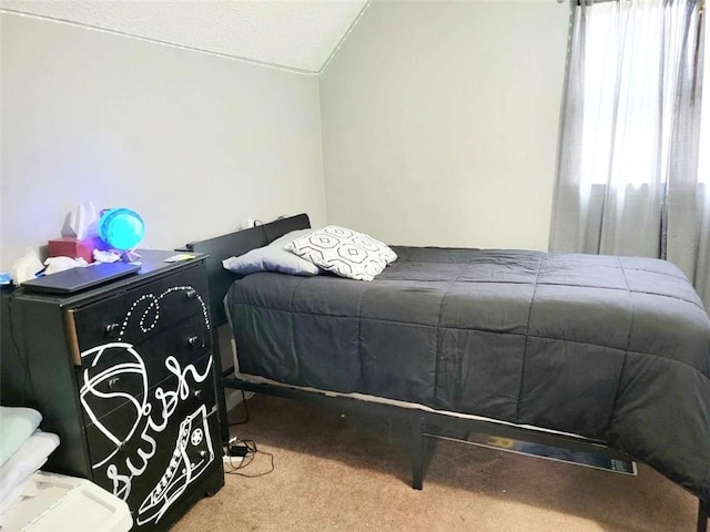 carpeted bedroom featuring lofted ceiling