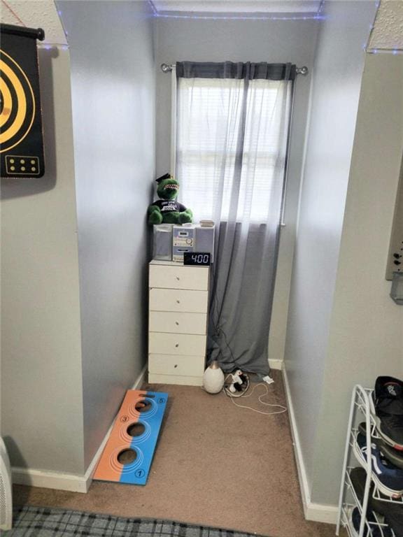 carpeted bedroom featuring baseboards