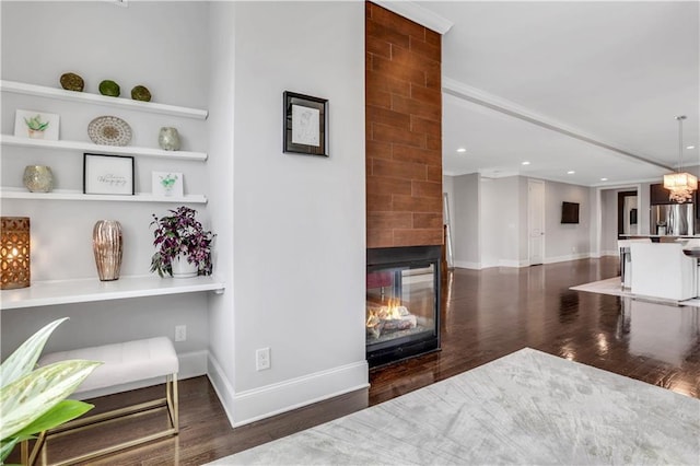 4550 Lois St SE, Smyrna, GA 30080 - living room with wood finished floors, a multi sided fireplace, baseboards, recessed lighting, and built in shelves