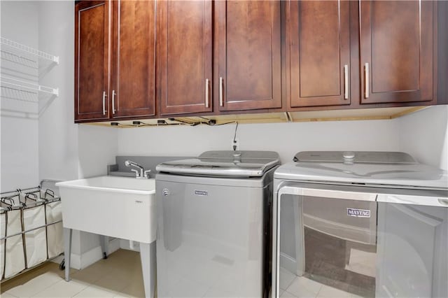 4550 Lois St SE, Smyrna, GA 30080 - laundry area with cabinet space, washer and clothes dryer, and light tile patterned floors