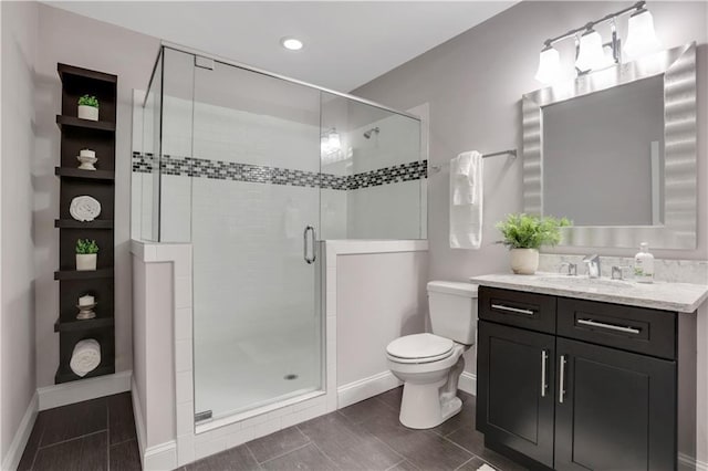 4550 Lois St SE, Smyrna, GA 30080 - bathroom featuring baseboards, toilet, a stall shower, vanity, and wood tiled floors
