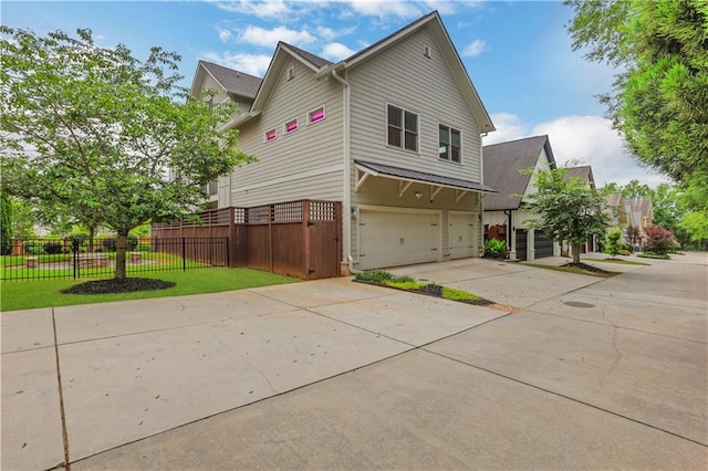 4550 Lois St SE, Smyrna, GA 30080 - view of side of home with concrete driveway and an attached garage