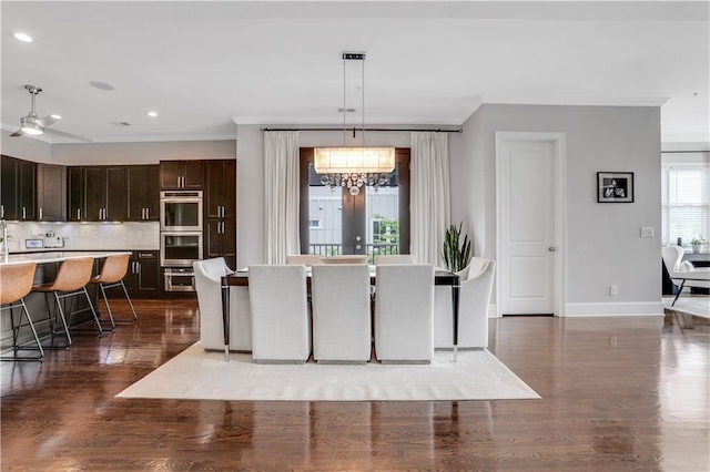 4550 Lois St SE, Smyrna, GA 30080 - dining space featuring a chandelier, crown molding, baseboards, wood finished floors, and recessed lighting