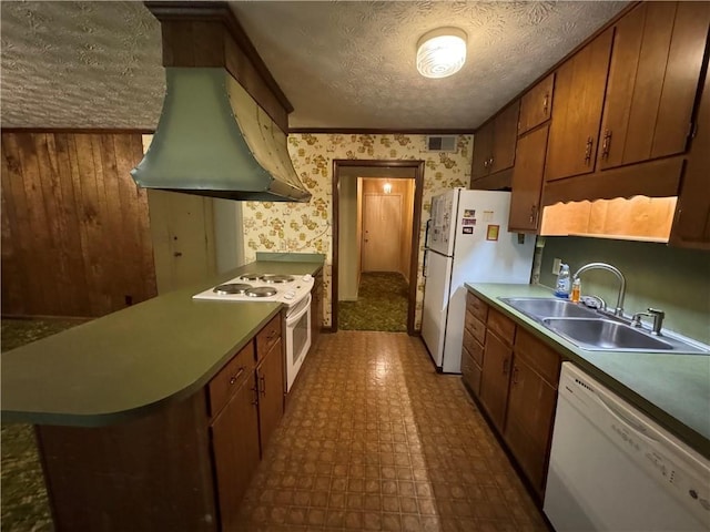 kitchen with a textured ceiling, visible vents, a sink, dark floors, and white appliances