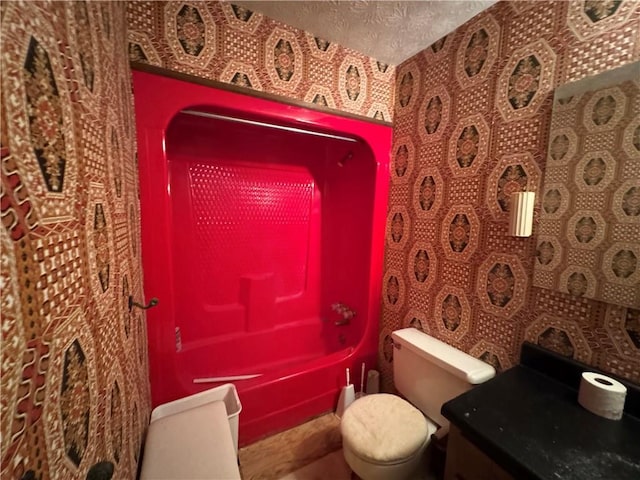 full bath featuring toilet, a textured ceiling, and vanity