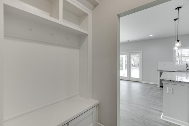 mudroom with baseboards, light wood-style flooring, french doors, a sink, and recessed lighting