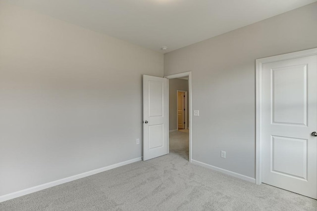 unfurnished bedroom featuring carpet flooring and baseboards