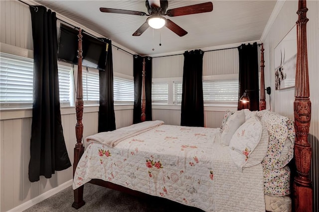 carpeted bedroom featuring multiple windows, ceiling fan, and ornamental molding