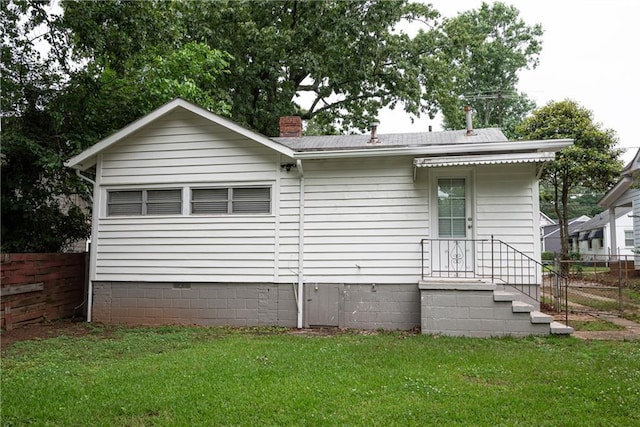 rear view of property with a yard