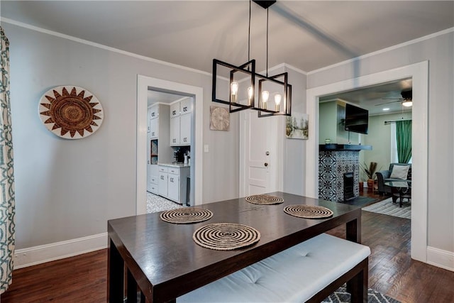 dining room with ceiling fan with notable chandelier, dark hardwood / wood-style floors, and ornamental molding