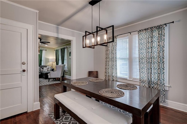 dining room featuring ornamental molding, ceiling fan with notable chandelier, and dark wood-type flooring