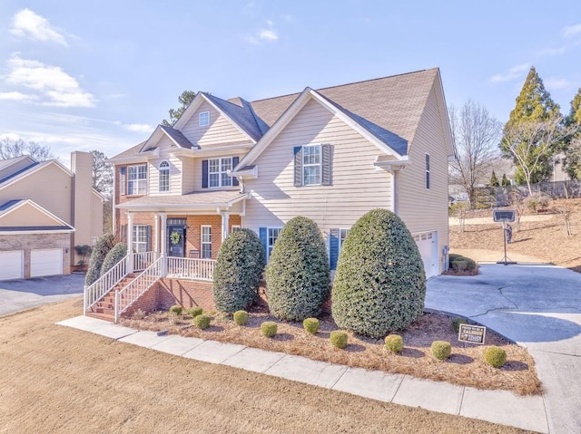 view of front of home featuring covered porch and a garage