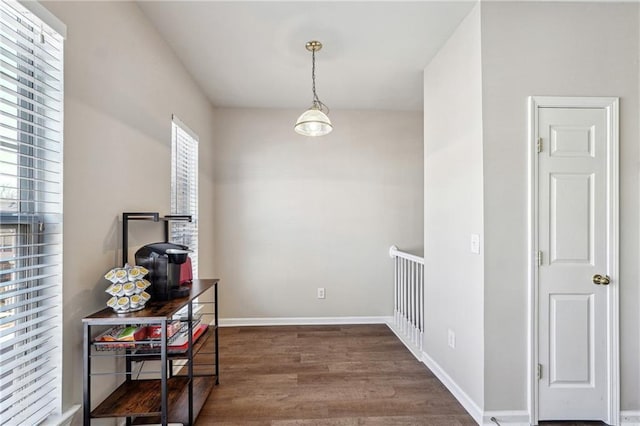 interior space with baseboards and wood finished floors